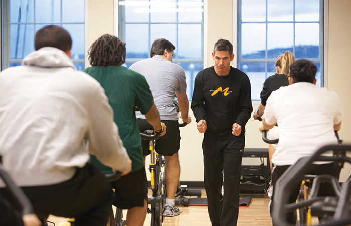 An instructor leading a cycling class at the MAC.