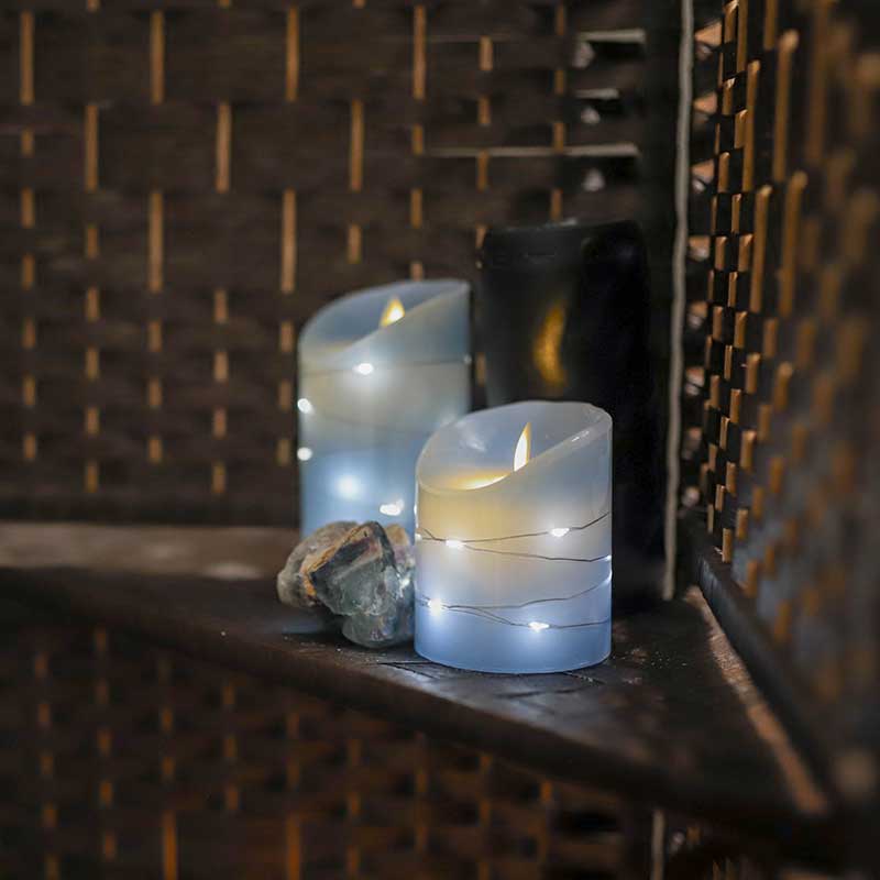 Two candles burn, providing a soothing light in the Massage Lounge at Magnuson Athletic Club